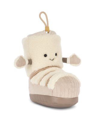 A plush boot-shaped keychain or bag charm featuring a cream-colored sherpa body, a beige corduroy-textured toe, and a small smiling face with black eyes and a stitched smile. It has small fabric hands and a tan hanging loop at the top, shown on a plain white background.