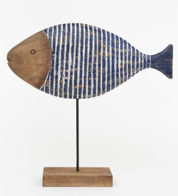 Decorative fish sculpture with striped pattern on a stand against a white background