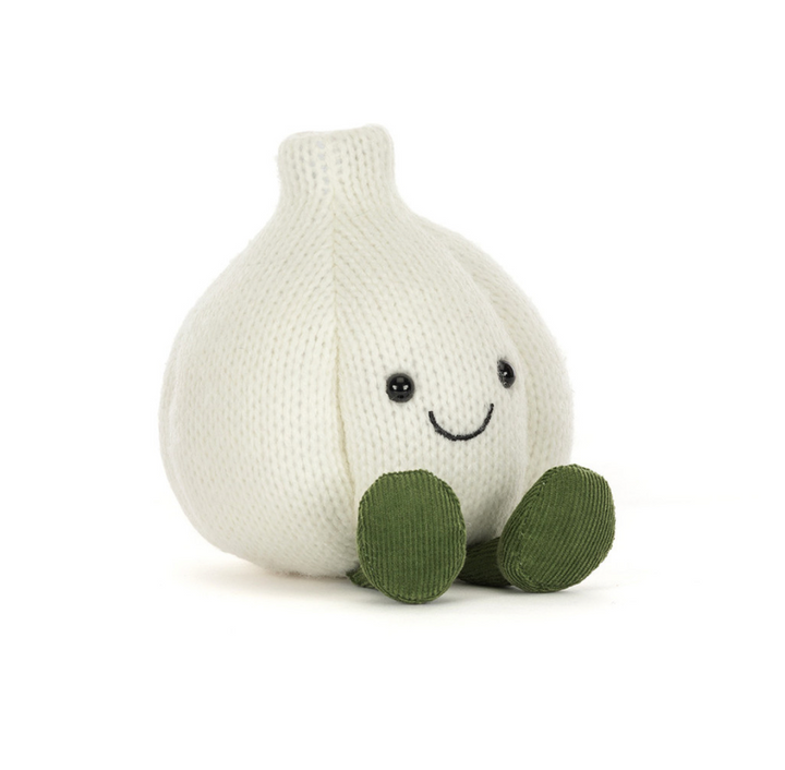 A knitted garlic plush toy with a smiling face and green feet, photographed on a clean white background.