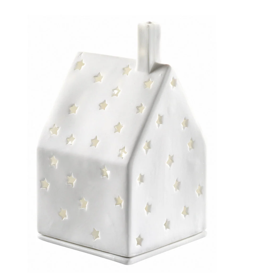 A white house-shaped ceramic lamp or decorative holder with star-shaped cutouts, shown on a plain white background.