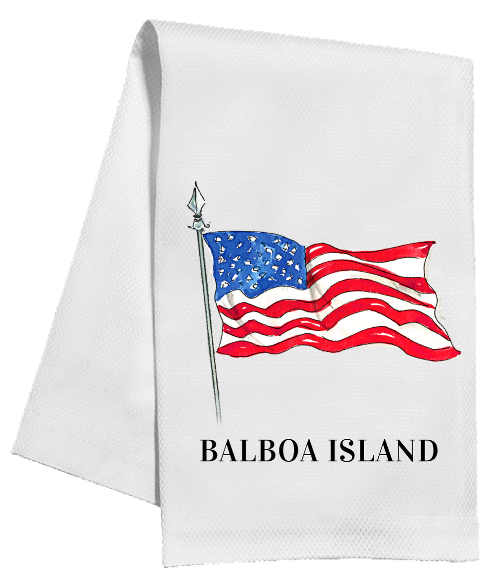 A white kitchen towel featuring a printed illustration of the Balboa Island flag and the text 'BALBOA ISLAND' in black capital letters below it.