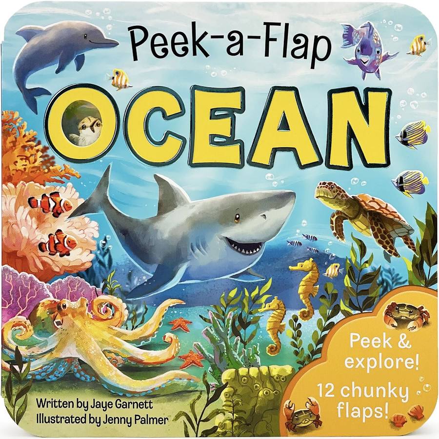 Front cover of the children's board book 'Peek-a-Flap Ocean' featuring a colorful underwater scene with a shark, dolphin, octopus, turtle, seahorse, clownfish, and tropical fish. The title is written in large yellow letters, with text noting it is written by Jaye Garnett and illustrated by Jenny Palmer.